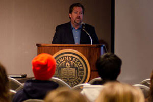 Presenter speaks at a Host a Friday event.